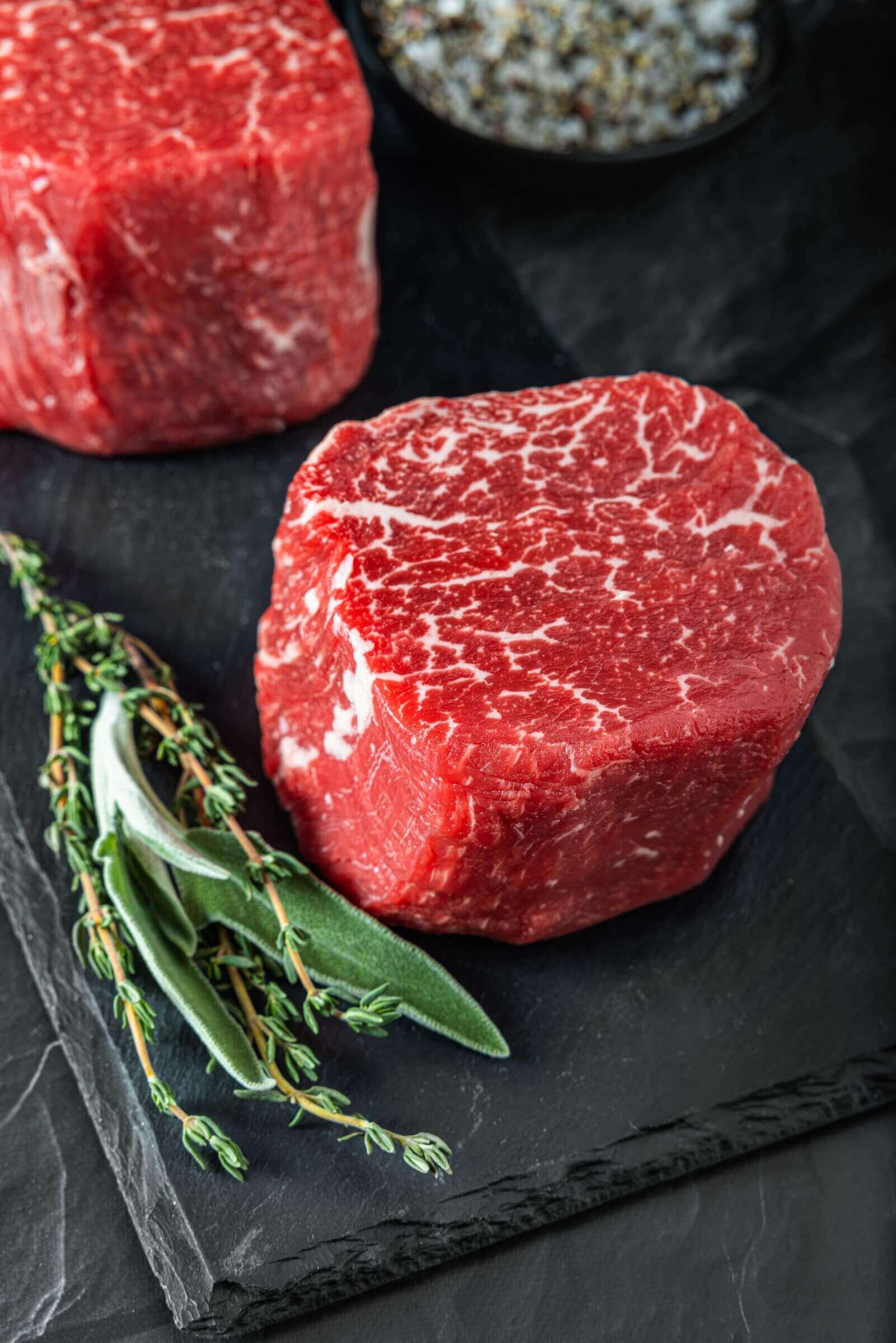 Stylized flatlay showing a Tenderloin Filet Steaks on a black table