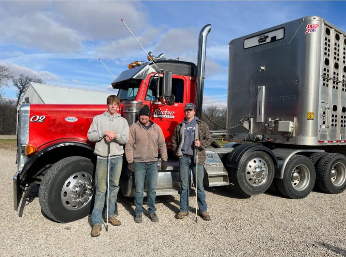 The Peterson Family in front of a semi