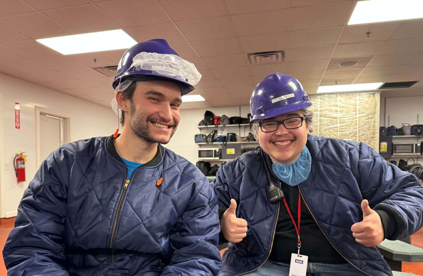 Two workers matching in their work gear.