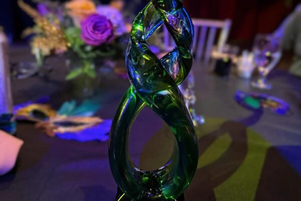Safety Chain award, green glass trophy pictured on black tablecloth table of event center.
