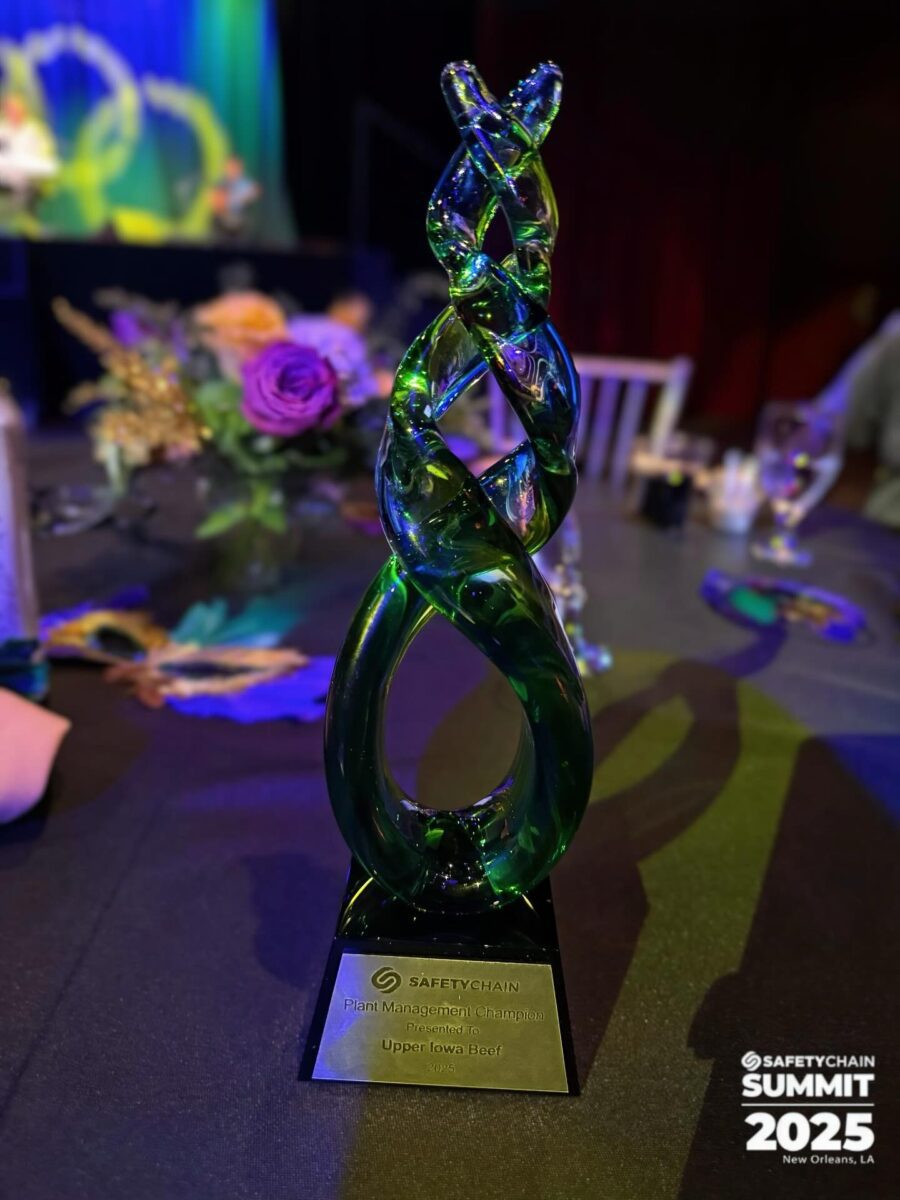 Safety Chain award, green glass trophy pictured on black tablecloth table of event center.