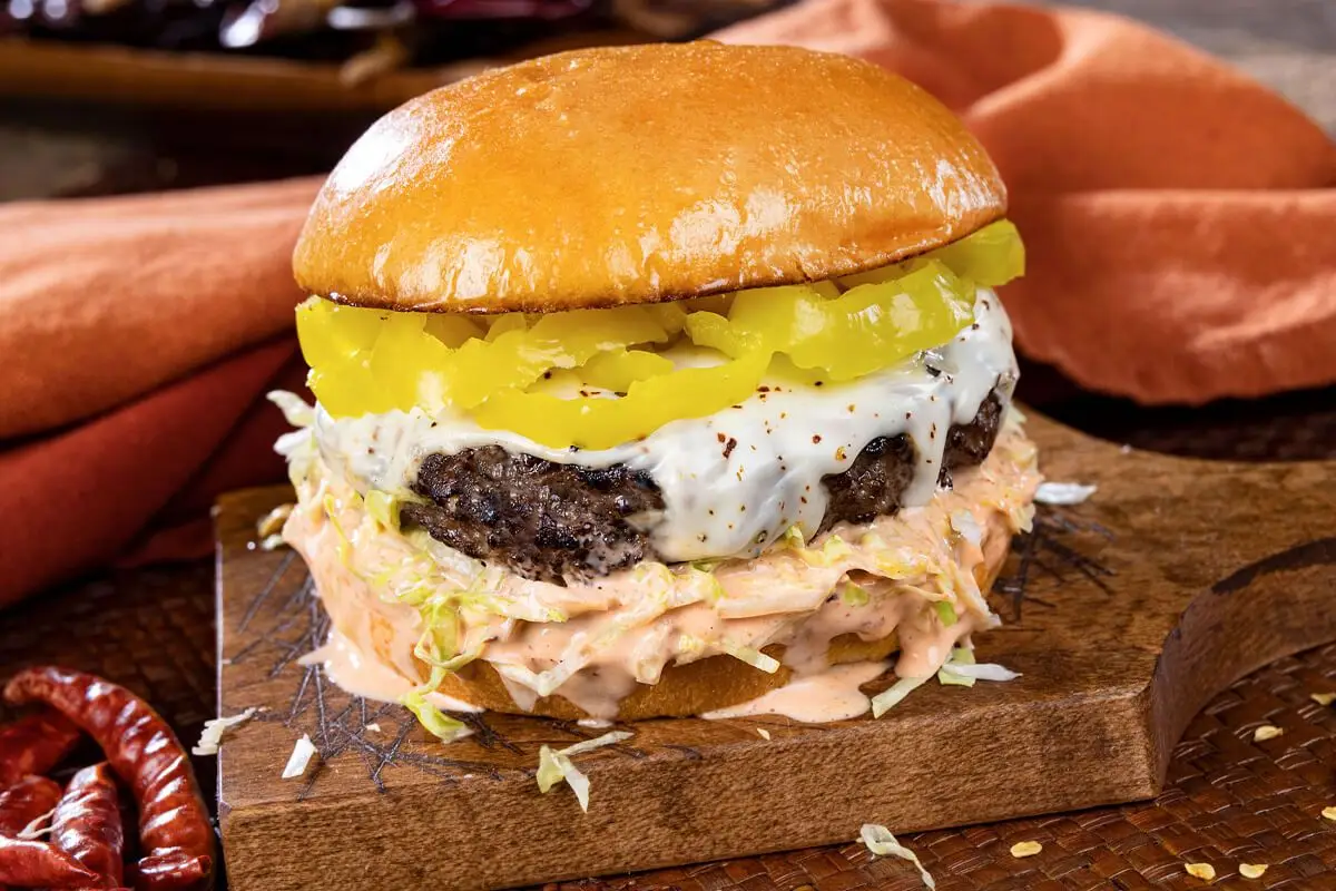 Best Pepper Jack Burger, banana peppers, pepper jack cheese, coleslaw, wooden tray.