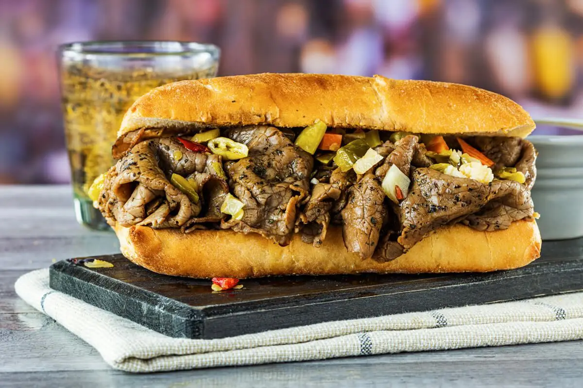 Chicago Roast Beef Sandwich, yellow bun with diced cooked red and green peppers, sliced beef.