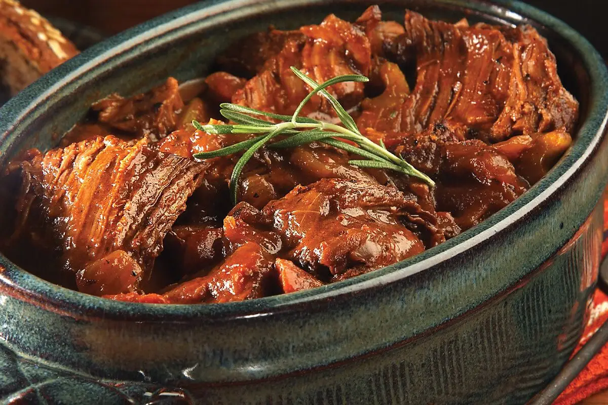 Easy Pot Roast, green pot with green rosemary leaves on top.