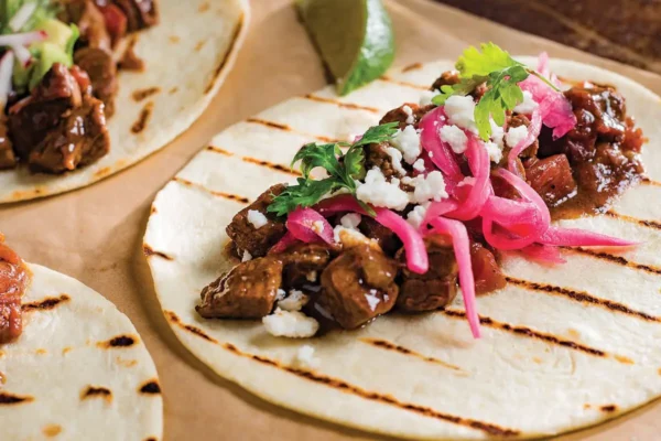 Slow Cooker Carne Picada, pickled red onions, flour tortilla, diced onions and cilantro.