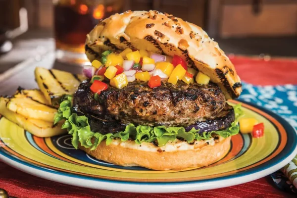 Sweet Jamaican Burger, mango pico de gayo on a beef burger with lettuce and pineapple.
